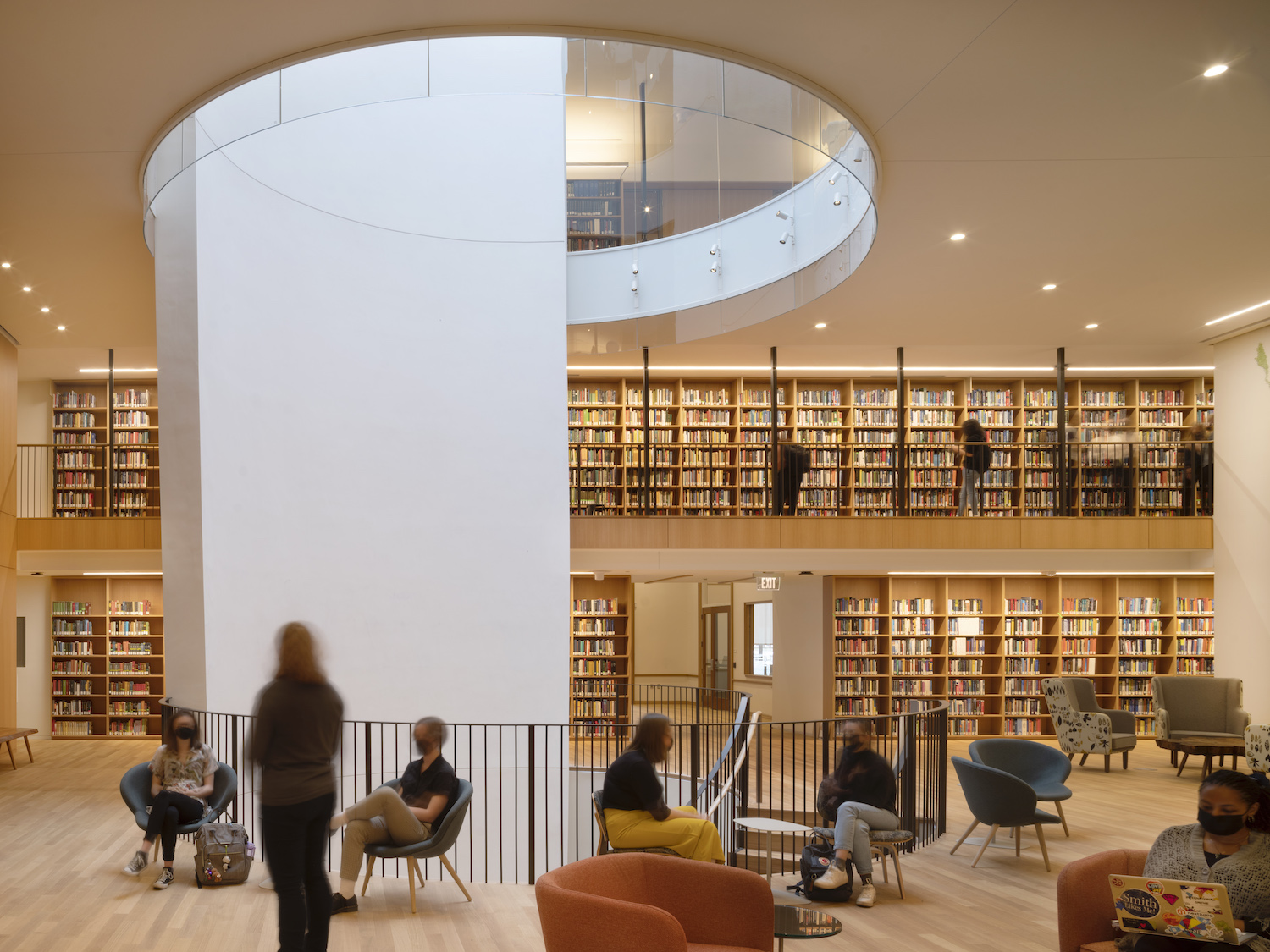 Neilson Library interior—students studying in book lined space under round oculus skylight