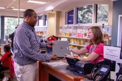 Patron checking out a laptop at a Georgia library
